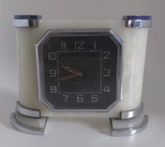 An 8 day Swiss made Lapis Lazuli 1940's Art Deco mantel clock, standing on chrome feet. slight