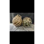 2 x   large glass fishing floats complete with original rope. One amber, one green. Approximately