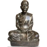 A Thai devotional figure modelled as a seated priest /monk seated in the lotus position on plinth