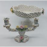 A pair of early 20th century German porcelain figural and flower encrusted candelabra, each with