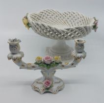 A pair of early 20th century German porcelain figural and flower encrusted candelabra, each with