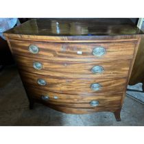 A George III mahogany bow front chest of four long graduated drawers, stamped oval brass and ring