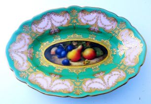 A Royal Worcester oval dish, c1900, painted with pears and grapes by R. Seabright within a peach and