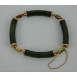Chinese green jadeite bracelet with 14k gold marked clasp and links featuring Chinese characters.