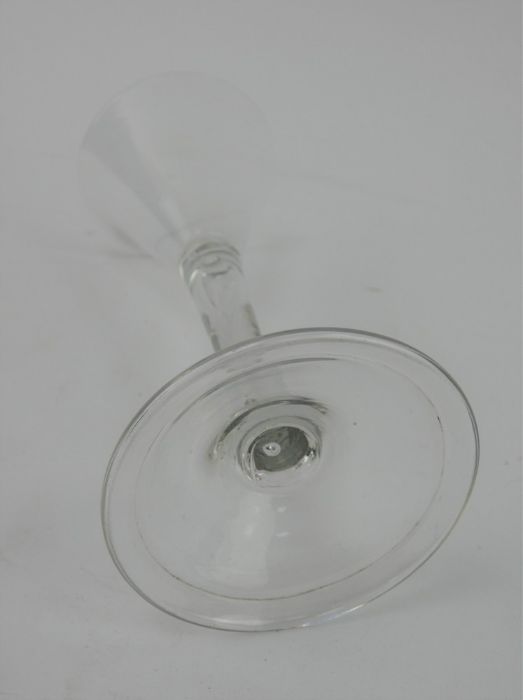 An 18th century drinking glass with trumpet bowl, tear drop stem and folded foot. Height 15.5cm - Image 3 of 6