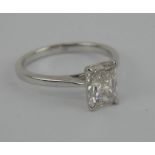 A 1.5ct solitaire diamond ring with radiant cut stone in an unmarked white metal setting. Stone 8mm