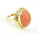 18ct gold ring set with central coral cabochon set within a foliate setting. Size K. Gross weight 4.