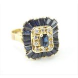 14ct gold diamond and sapphire cocktail ring with central stone set on a cushion of sapphires and di