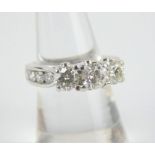 14ct white gold trilogy diamond ring with diamond inset shoulders and spacers