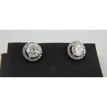 Pair of 2ct diamond 18ct white gold earrings. Each earring with a central 1ct diamond