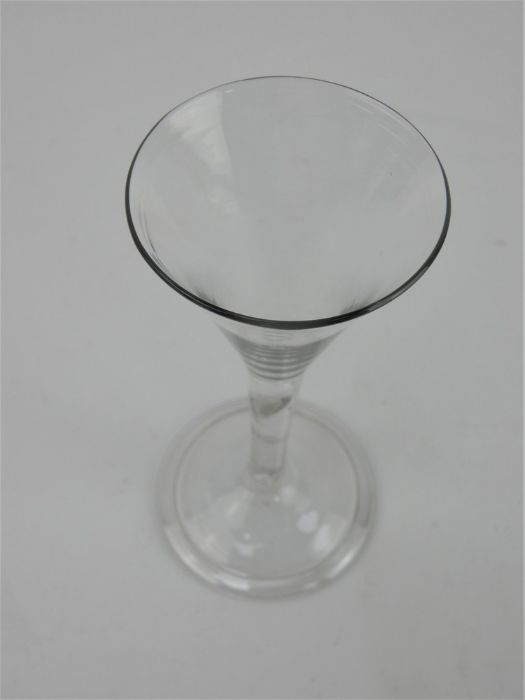 An 18th century drinking glass with trumpet bowl, tear drop stem and folded foot. Height 15.5cm - Image 2 of 6