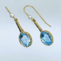 A collection of earrings. Featuring a pair of hallmarked 9ct gold Swiss blue topaz and cultured