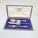 A George V Sterling silver uninitialed christening set, comprising a pierced work and floral