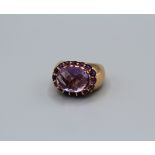 An amethyst set Italian dress ring in rose-pink metal. Featuring a rose/mixed cut central