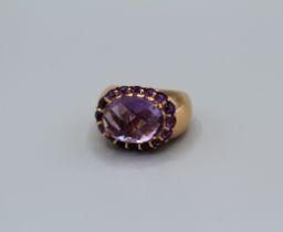 An amethyst set Italian dress ring in rose-pink metal. Featuring a rose/mixed cut central