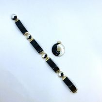 An onyx and mother of pearl yin and yang bracelet in 14ct gold along with a yellow metal and