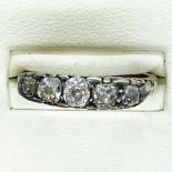 A Victorian carved mount five stone diamond half hoop ring. Featuring five old mine cut diamonds.