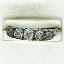 A Victorian carved mount five stone diamond half hoop ring. Featuring five old mine cut diamonds.