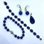 A collection of lapis lazuli jewellery. Featuring a "14k" stamped yellow metal and lapis lazuli