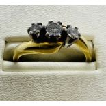 An 18ct gold three stone diamond ring. Estimated total weight of diamonds 0.25 carats, Size L.