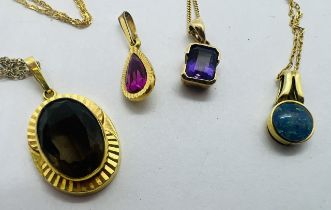 A collection of four pendant and chains. Featuring a 9ct yellow gold emerald cut Amethyst pendant,