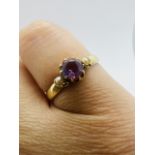 An amethyst and seed pearl ring in yellow metal. Stamped "15ct" to the shank. Size L. Approximate