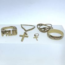 A collection of gold jewellery to include; Two 9ct gold crosses, one "Paul" ring and a 9ct jigsaw