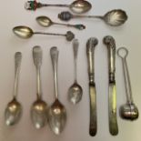 An assortment of sterling silver. Comprising a selection of teaspoons, a tea strainer and two silver