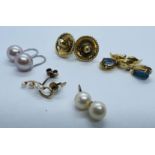 A collection of earrings. Featuring a pair of white metal shepherd hook earrings with drops of