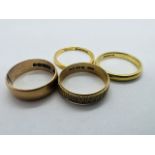 A collection of four yellow gold band rings. Comprising a 22ct gold band ring (size M; approximate