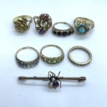 A number of jewellery items to include various rings and a brooch