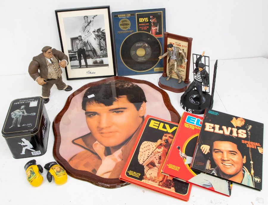 Large collection of Elvis Presley memorabilia including clocks, pictures, books, belt buckles, mugs,