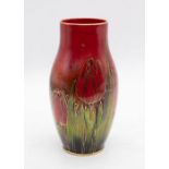 Harry Nixon for Royal Doulton - A Flambe vase of slender shouldered form, decorated with tulips,