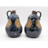 Royal Doulton - A pair of early 20th Century globular form stoneware looped handled vases, with tube