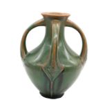 A large Art Nouveau Continental art pottery vase, with four curved stylised handles and footed base.