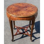 A 20th Century burr walnut table, having four stylish curved and ribbed legs with a curved and