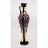 Moorcroft Pottery: A Moorcroft collectors club slender, handled baluster vase in ' Fuchsia