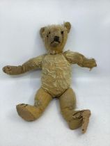 Antique 14” teddy bear; very worn condition and has been repaired through his life and is looking