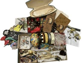 An interesting collection of costume jewellery to include plastic bangles and brooches, a ww11