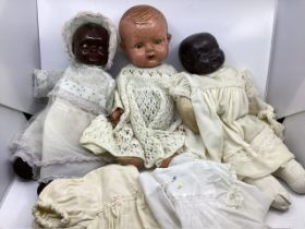 1930s antique composition dolls, 2 with painted faces and black colouring and a tin eyes baby