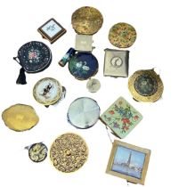 A collection of vintage compacts to include a Stratton compact with swan design and matching