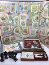 An Antique Board and boxed lead original playing pieces of the Peter rabbit Race game, with a folded