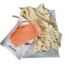 An Issey Miyake 'pleats please' pouch handbag in an ombre orange sherbet and an ivory Issey Miyake