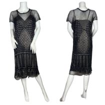 A 1920s assuit dress in black. The net ground being covered in hammered metal in geometric diamond