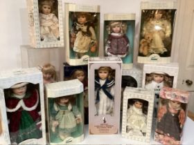 A good selection of Boxed modern porcelain dolls, in boxes including one of a wooden rocking nursery