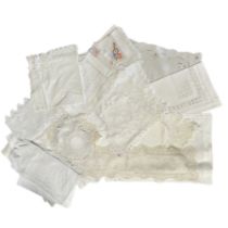 A quantity of fine quality antique and early vintage table linens to include 4 tape lace trimmed