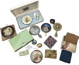 A collection of vintage compacts to include a boxed Kigu set with peacock design, an unusual