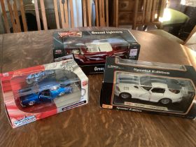 3 larger scale model cars to include a grease movie vehicle and a Dodge Viper car and and another-