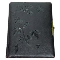 A 19th century leather bound photo album in a textured leather embossed with trailing  ivy leaves.