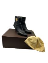 A pair of Louis Vuitton ankles boots in black leather with gold tone studs and hardware. size 37